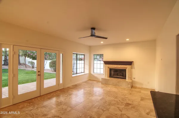a view of an empty room with a fireplace and a window