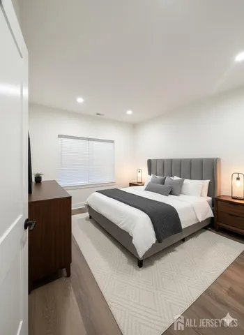 a bedroom with a bed and a flat screen television