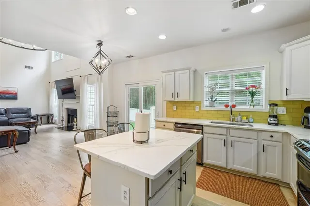 a kitchen with a stove a sink and a refrigerator