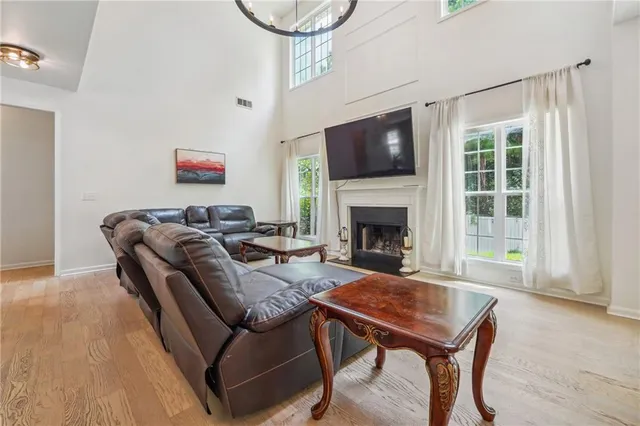 a living room with furniture a flat screen tv and a table