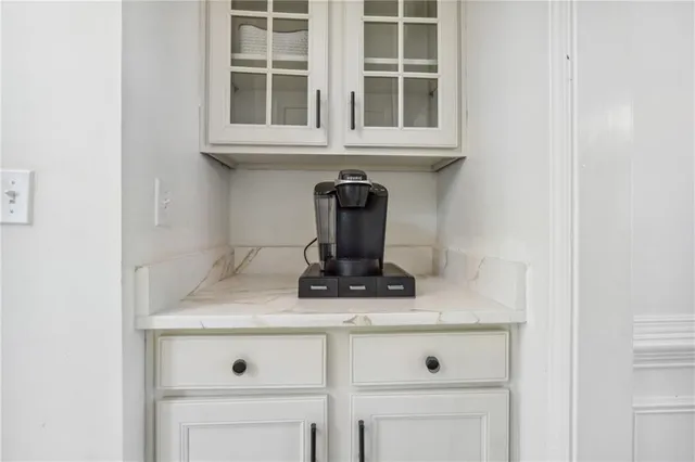 a kitchen with a sink a counter top space stainless steel appliances and cabinets