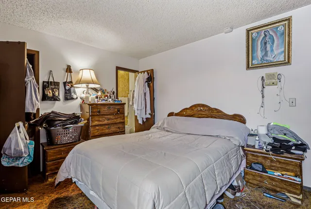 a bedroom with bed and furniture