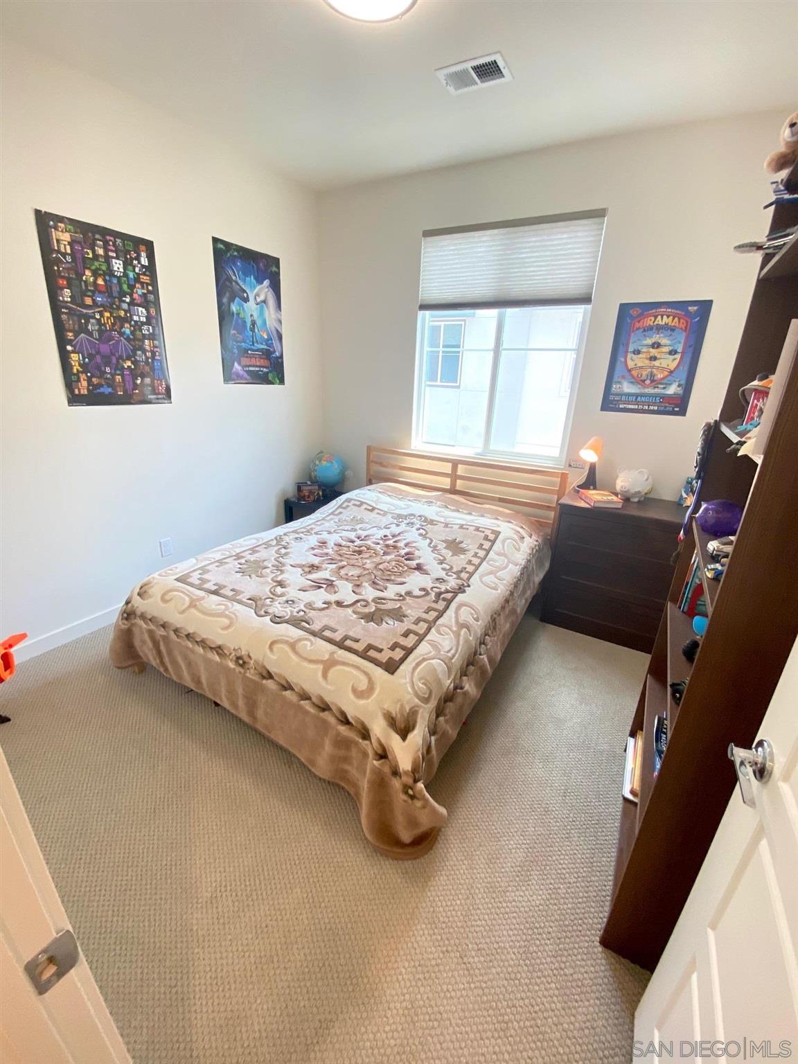 2135 Celestial Way, Unit 2 Chula Vista, CA 91915 - Photo 16 of 24 a bedroom with bed and a window