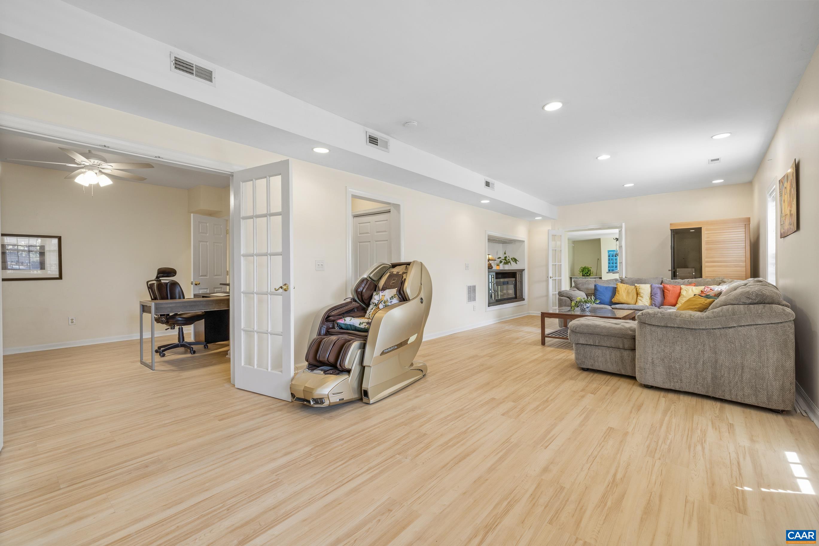 1236 Amber Ridge Road Charlottesville, VA 22901 - Photo 39 of 56 a living room with furniture and a wooden floor