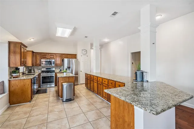 a kitchen with stainless steel appliances granite countertop a sink and cabinets