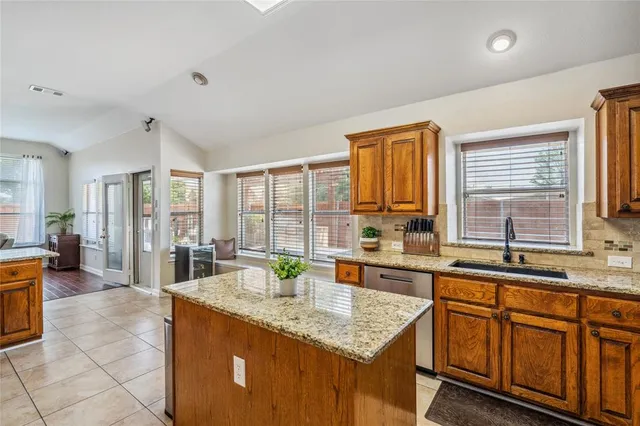 a kitchen with stainless steel appliances granite countertop a sink and cabinets