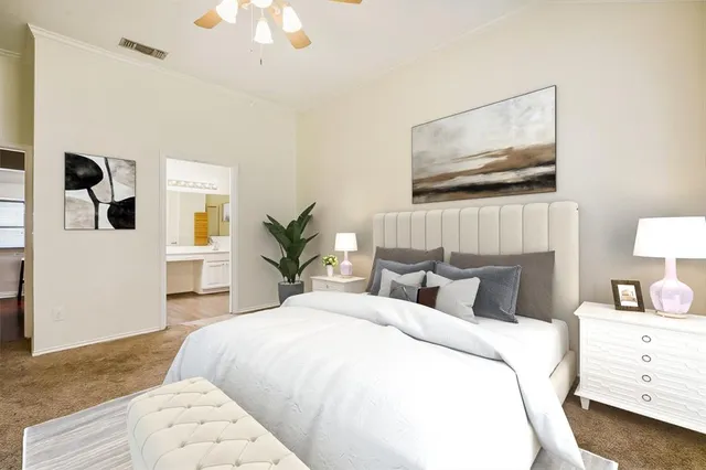 a bedroom with a large bed and a chandelier