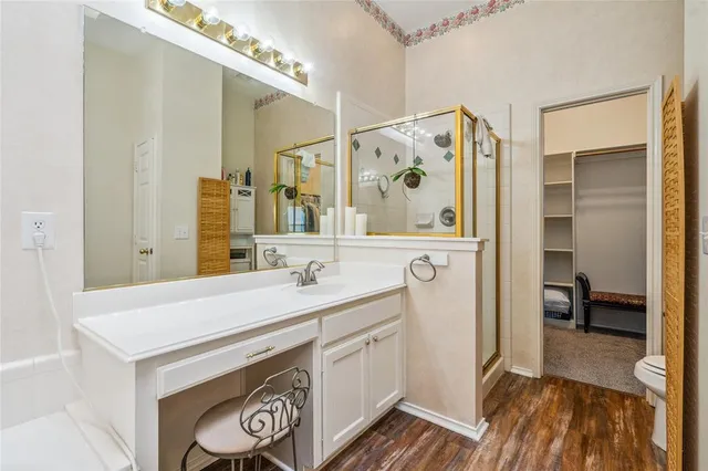 a bathroom with a sink a mirror and a shower