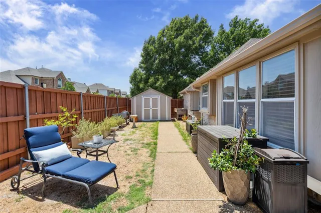 a view of a chairs and table in the backyard