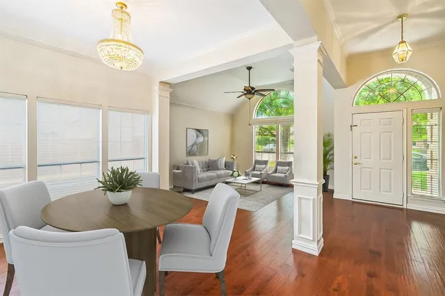 a view of a dining room with furniture wooden floor and chandelier