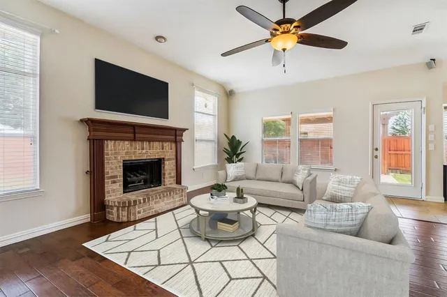 a living room with furniture a fireplace and a flat screen tv