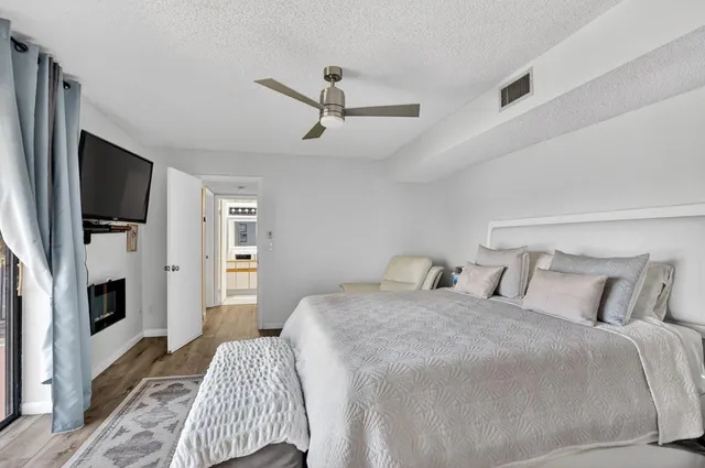 a bedroom with a bed couch and a window