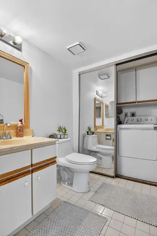 a bathroom with a sink a toilet and a mirror