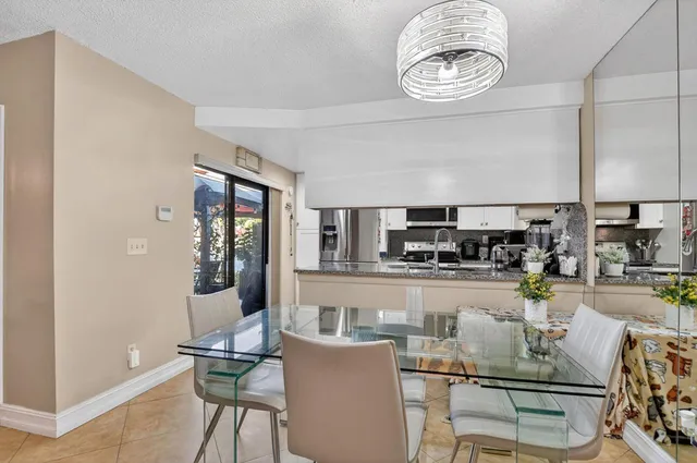 a kitchen with a dining table and chairs