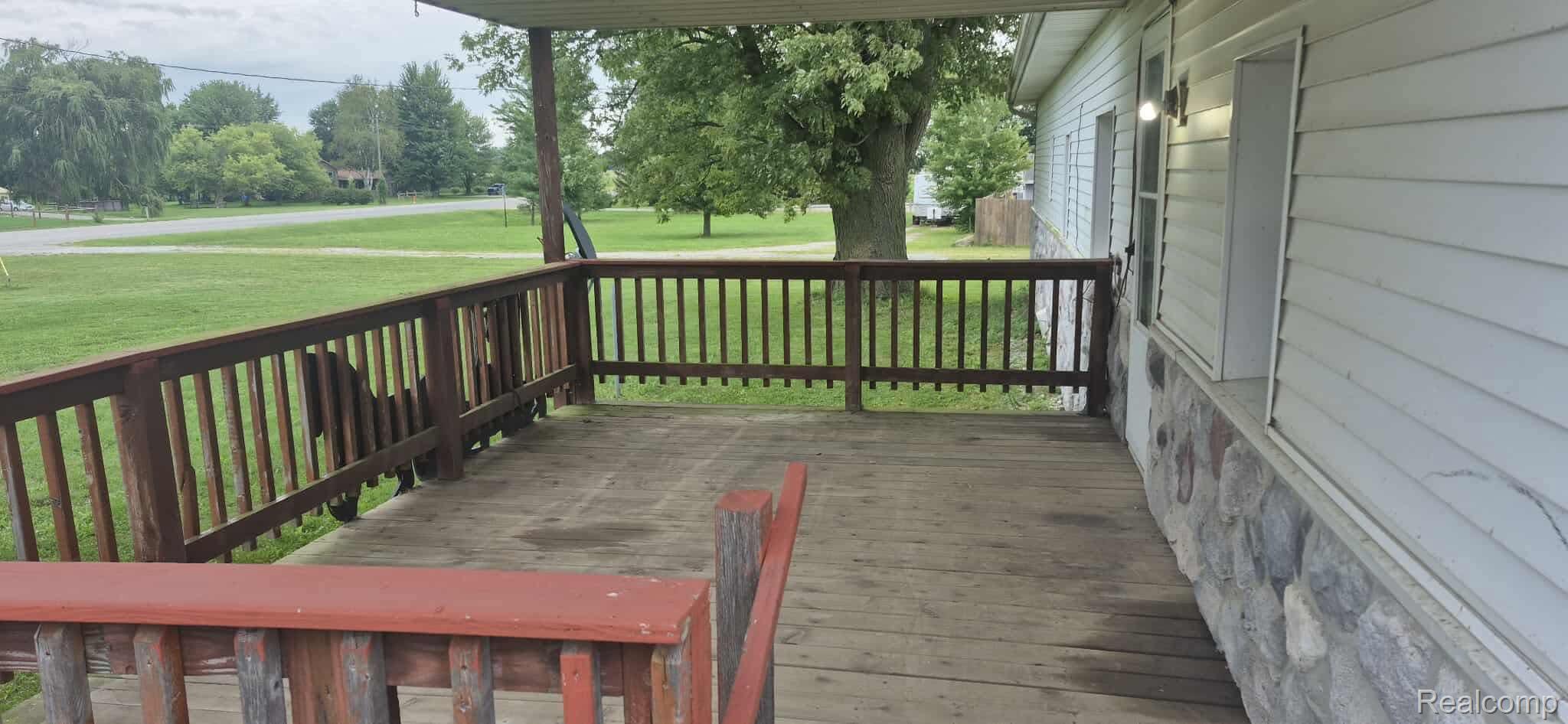 6935 Sanilac Road Marlette, MI 48453 - Photo 5 of 23 Deck featuring a lawn