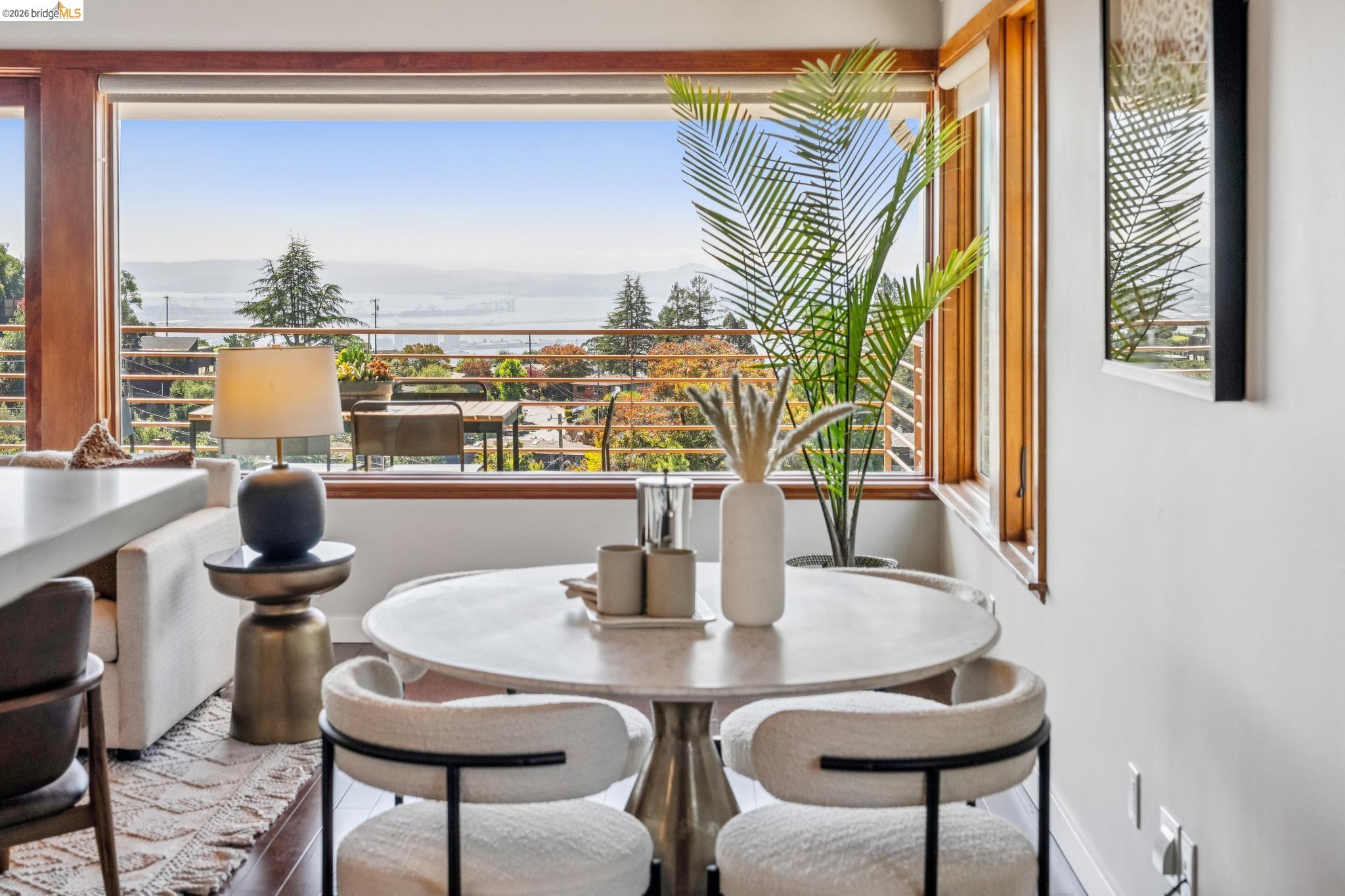 1394 Queens Road Berkeley, CA 94708 - Photo 9 of 63 Expansive window framing distant scenery, wood-finish window frames, light-toned walls, and wood-finish flooring