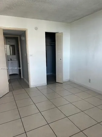 a view of an empty room and a window
