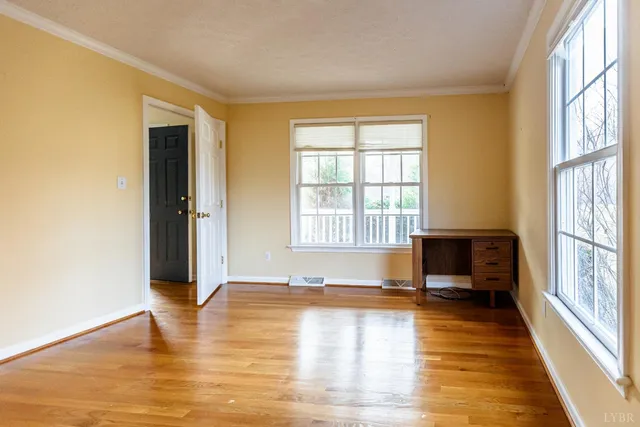 a kitchen with stainless steel appliances granite countertop a chairs and a refrigerator