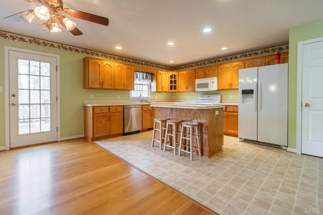 a kitchen with stainless steel appliances kitchen island granite countertop a refrigerator and a stove