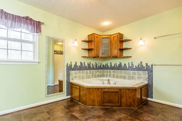 a bathroom with a sink a toilet a mirror and a window