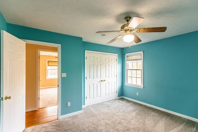 a dining room with wooden floor a chandelier a wooden table and chairs