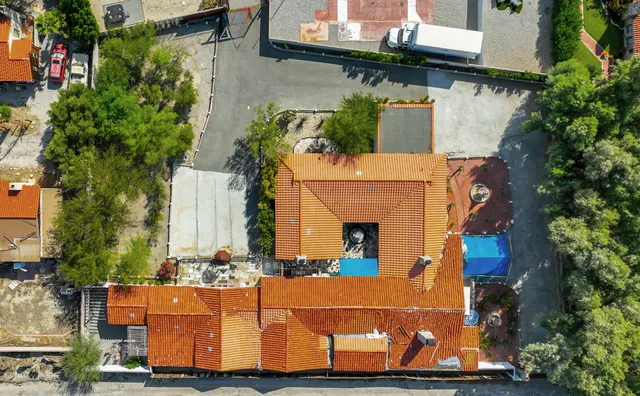 an aerial view of a house with street