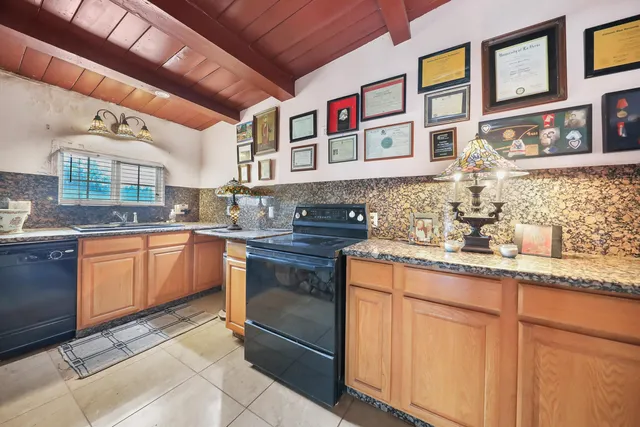a living room with furniture kitchen view and a flat screen tv