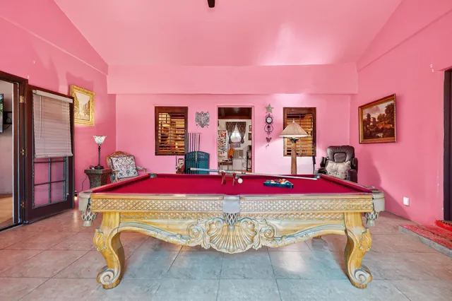 a living room with fireplace furniture and rug