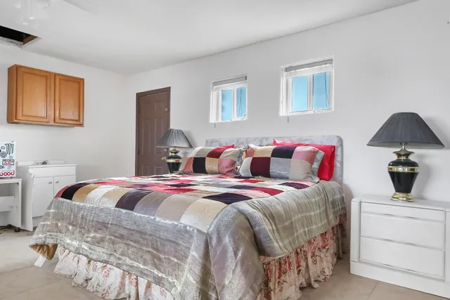 a bedroom with a bed a couch and a window