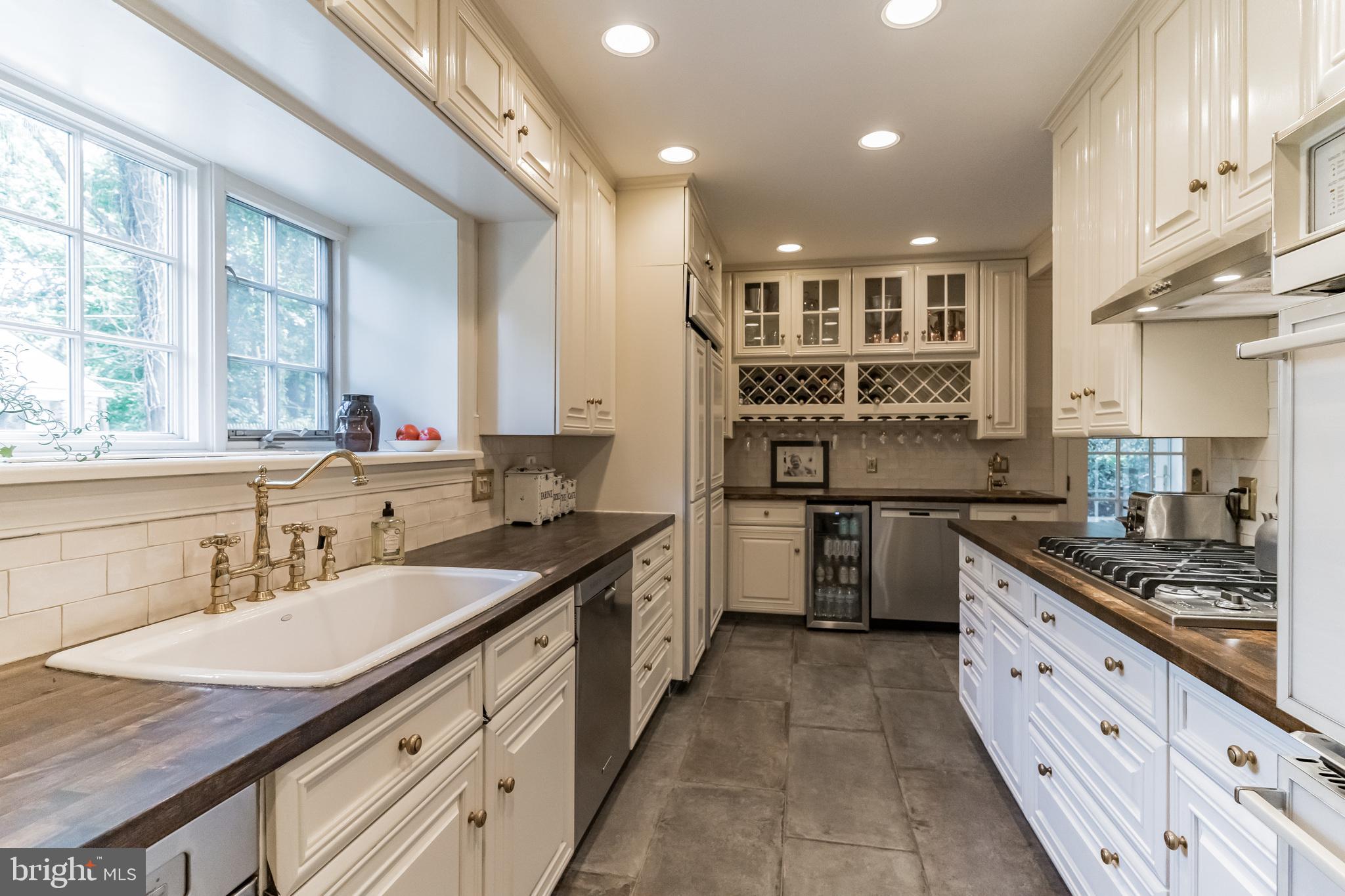 1413 Pepper Road Jenkintown, PA 19046 - Photo 13 of 65 a kitchen with stainless steel appliances granite countertop a sink stove and cabinets