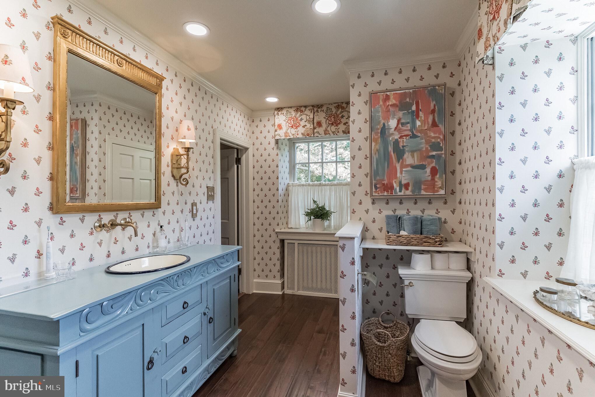 1413 Pepper Road Jenkintown, PA 19046 - Photo 30 of 65 a bathroom with a granite countertop toilet a sink a mirror a window and a shower