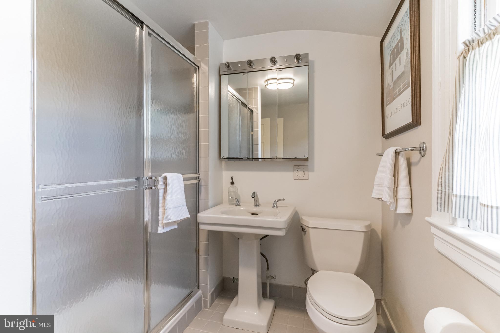 1413 Pepper Road Jenkintown, PA 19046 - Photo 39 of 65 a bathroom with a toilet sink and shower