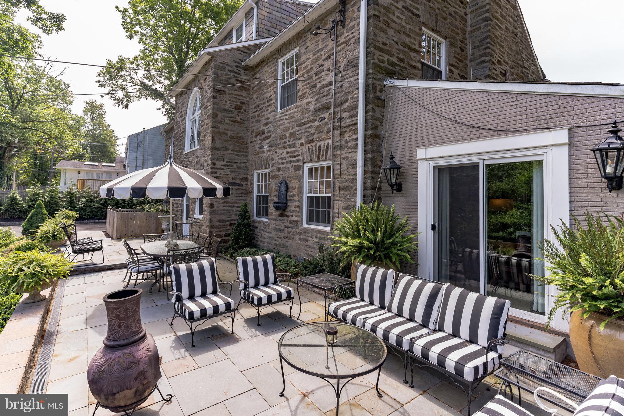 1413 Pepper Road Jenkintown, PA 19046 - Photo 42 of 65 a view of a patio with couches table and chairs and potted plants