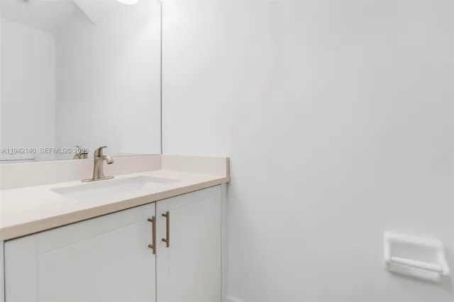 an empty room with a window and ceiling fan