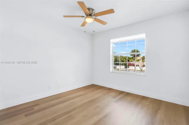 a view of an empty room with a ceiling fan