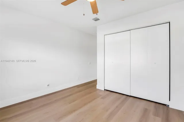 a bathroom with a tub sink vanity and a mirror