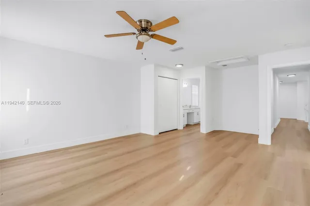 a view of empty room with ceiling fan