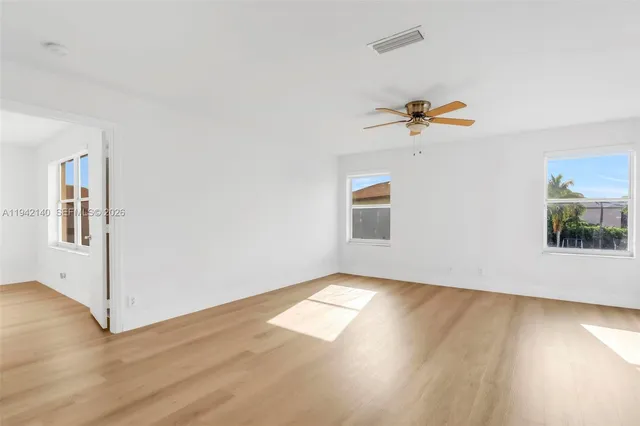 a view of a yard with a house in the background