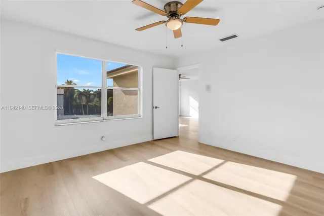 a swimming pool with yard and wooden fence