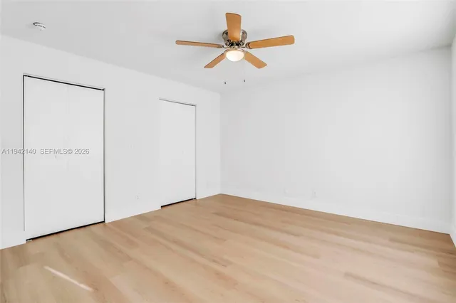 a view of a yard with wooden fence