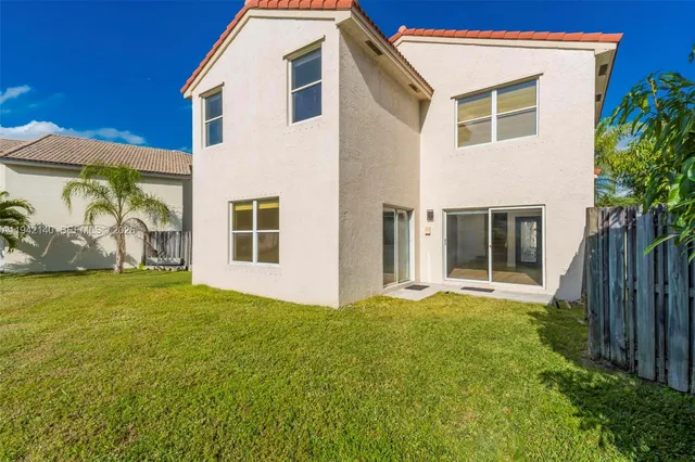 an aerial view of a house with a swimming pool