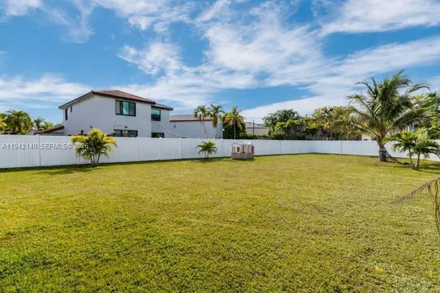 an aerial view of residential houses with outdoor space and swimming pool