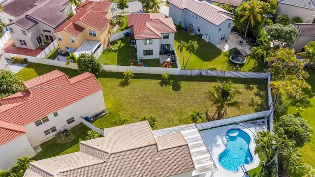 an aerial view of residential houses with outdoor space