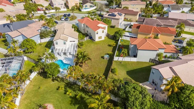 an aerial view of residential houses with outdoor space