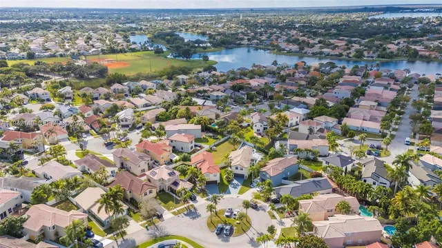 a front view of a house with a yard and potted plants