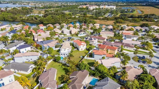 a view of a house with a swimming pool and a yard