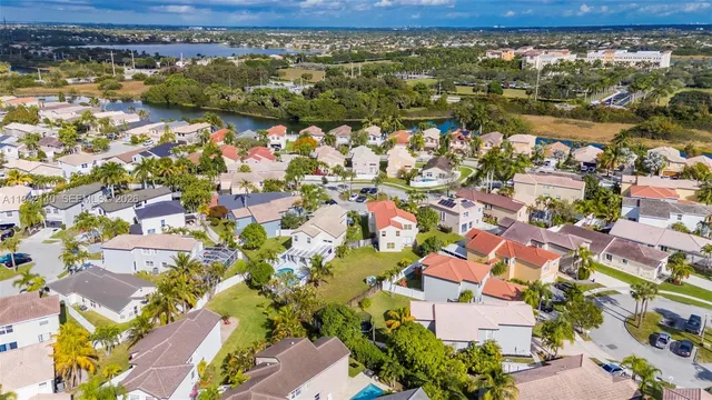 a front view of a house with a garden and plants