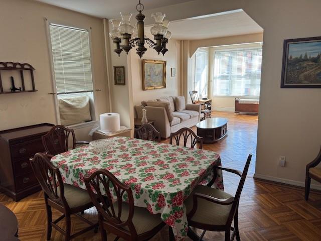 355 85th Street Brooklyn, NY 11209 - Photo 4 of 15 a dining room with furniture a chandelier and wooden floor
