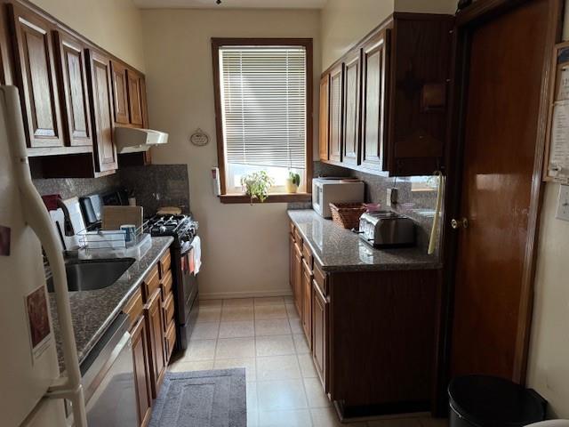 355 85th Street Brooklyn, NY 11209 - Photo 5 of 15 a kitchen with a sink stove and cabinets