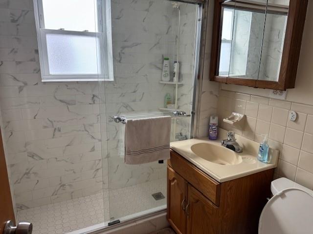 355 85th Street Brooklyn, NY 11209 - Photo 6 of 15 a bathroom with a sink and mirror with toilet